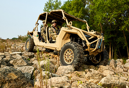A MRZR Alpha riding through a rocky road