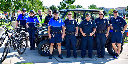 Government personnel pose with a Polaris utility vehicle