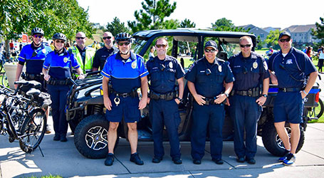 Government personnel pose with a Polaris utility vehicle