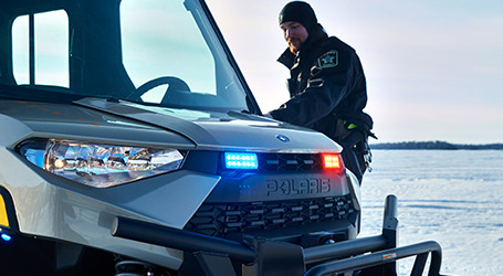 Two officers on Snowmobiles next to each other