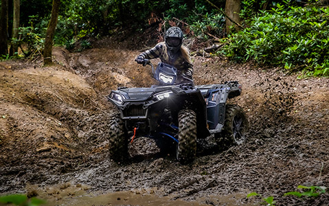 Polaris Sportsman on a muddy road