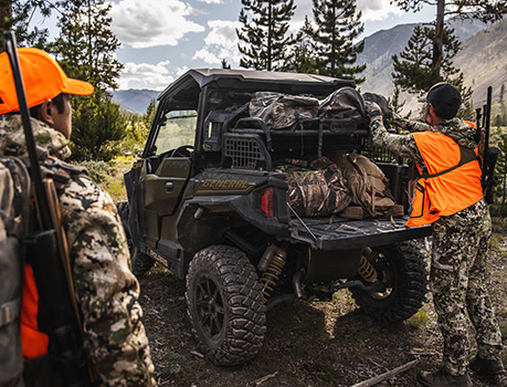 Two hunters and loading their equipment on a General vehicle