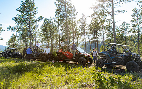 RZR Trail Family vehicles in a greenfield