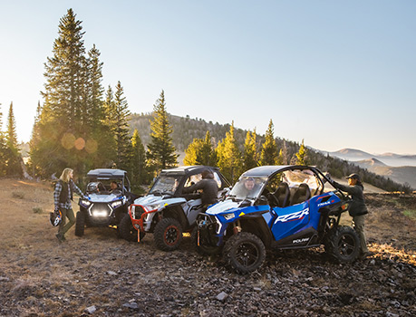 A group of RZR riders with their Trail vehicles