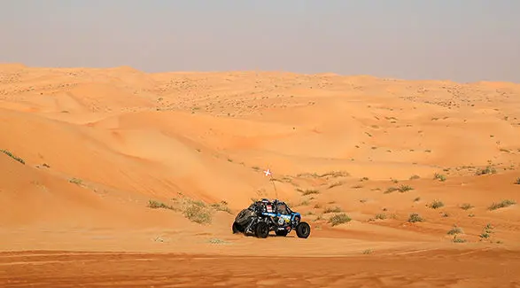 Dakar Rally RZR Pro R Factory vehicle driving through the desert.