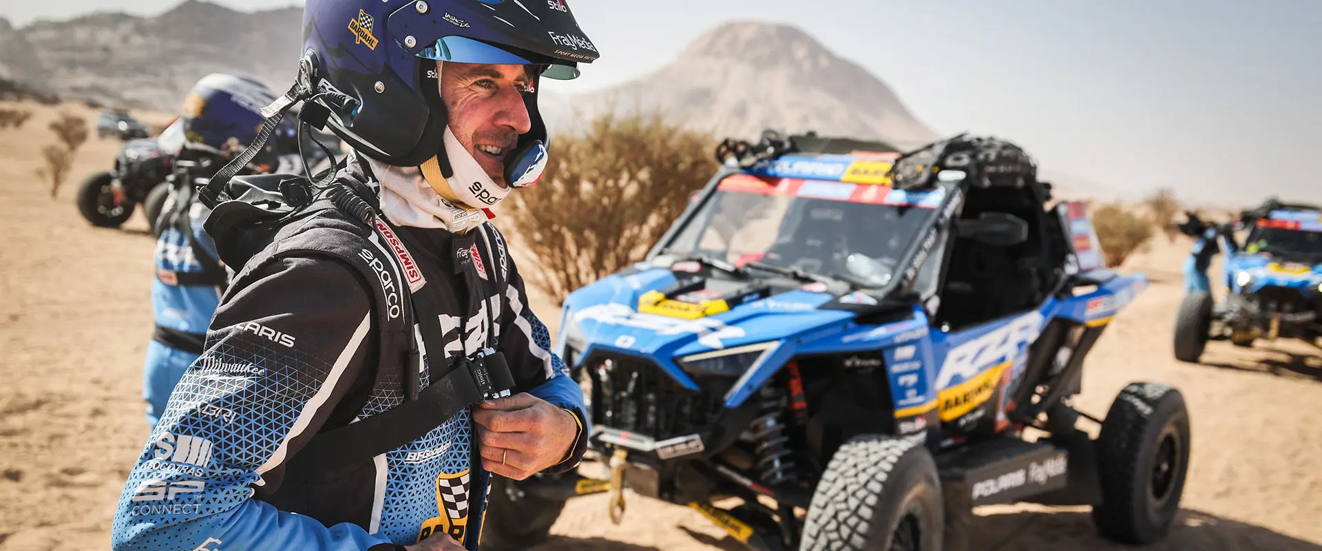 The Dakar Rally Pro driver Xavier de Soultrait, ready for race, with his RZR Pro R Factory in desert.