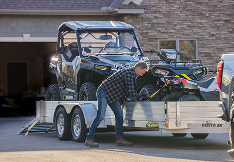 Preparing to transport a Polaris Off-Road vehicles on a trailer by properly securing it.