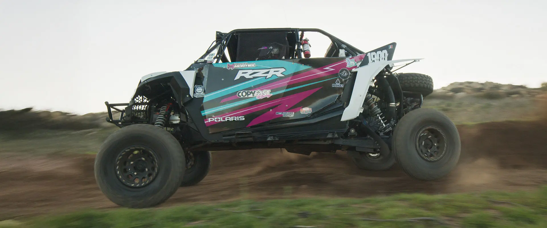 Polaris RZR SxS jumps through the air during off-road race. The vehicle is driven by Fernanda Montiel.