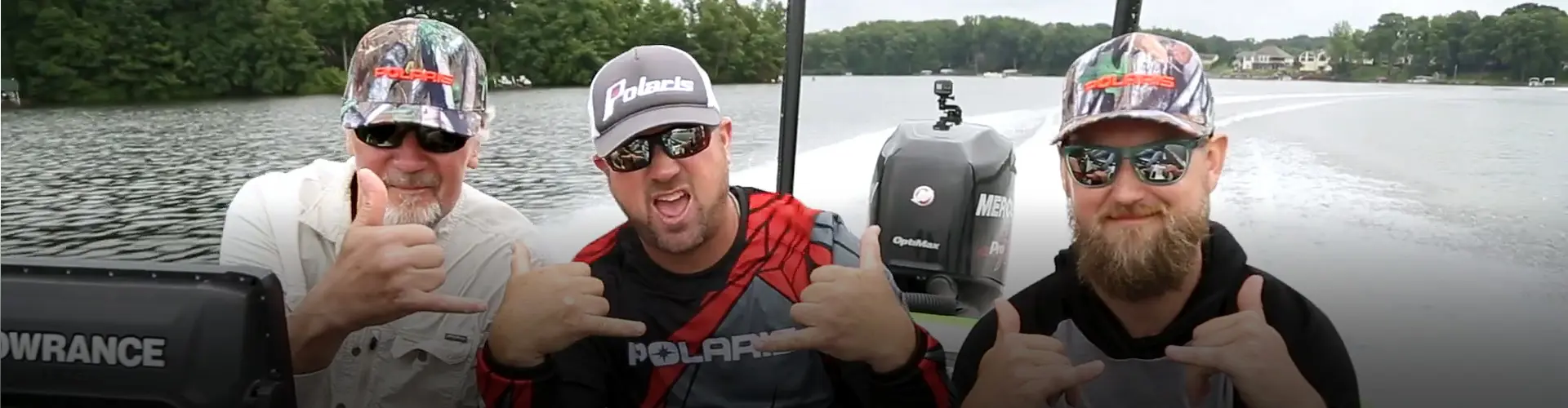 Gary F. Milton and his son join fishing with professional angler David Dudley from a boat on an Alaskan lake during the Polaris Ultimate RANGER Fishing Experience.