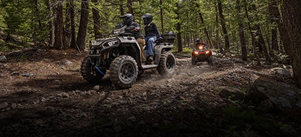 2 riders cruising on a 2-up touring ATV.