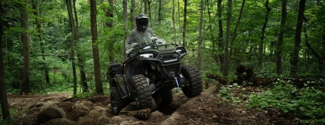 A rider on an ATV cruising over rocky terrain with ease.