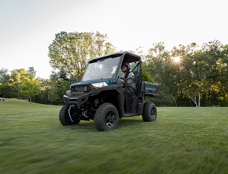 A Polaris RANGER UTV using the ground-protecting Turf Mode feature on a lush grass lawn.
