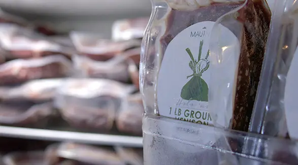 Close-up of a vacuum-sealed 1 lb package of Maui Nui Ground Venison.
