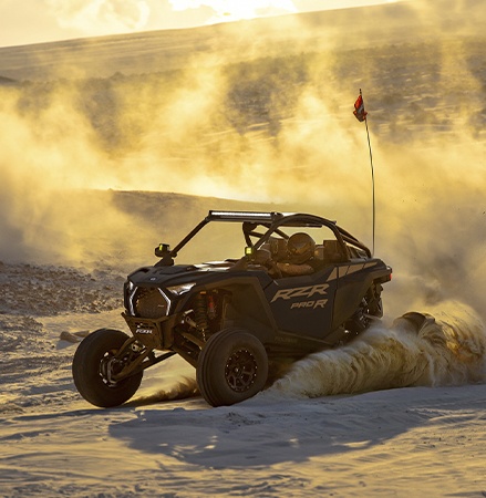 A rider in a Polaris RZR Pro R side-by-side that was rented from Polaris Adventures.