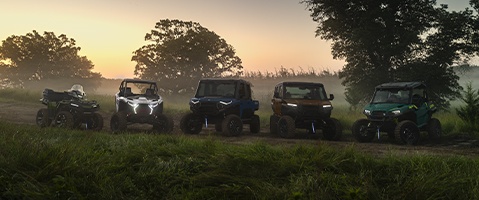 Lineup of Polaris Off-Road Vehicles on a dirty road.