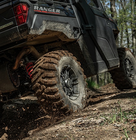 Polaris RANGER Crew XP 1000 NorthStar Trail Boss Edition UTV navigating a rocky forest trail on Pro Armor tires.