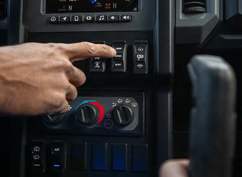 Close-up of the Polaris XPEDITION Side-by-Side interior showing climate controls and selectable drive modes on the center console.