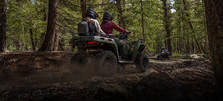 2 riders cruising on a 2-up touring ATV. 