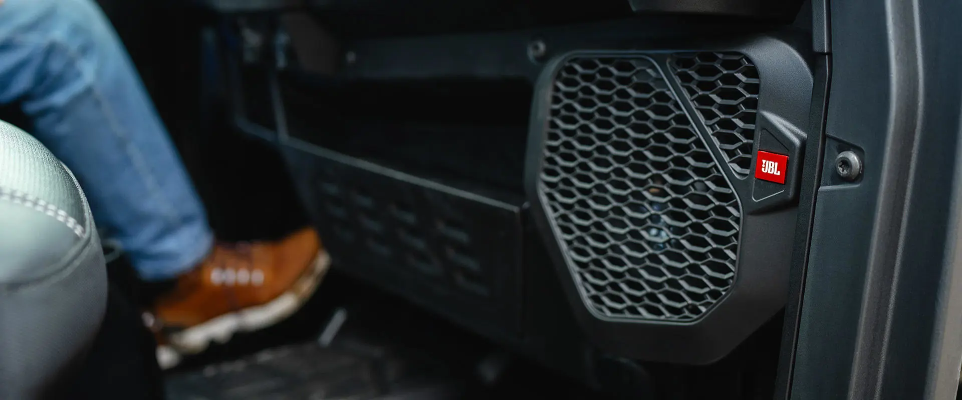 JBL speakers in the interior of a Polaris NorthStar enclosed cab side-by-side.