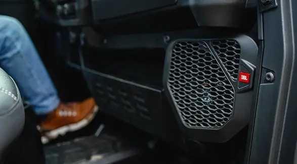 JBL speakers in the interior of a Polaris NorthStar enclosed cab side-by-side.