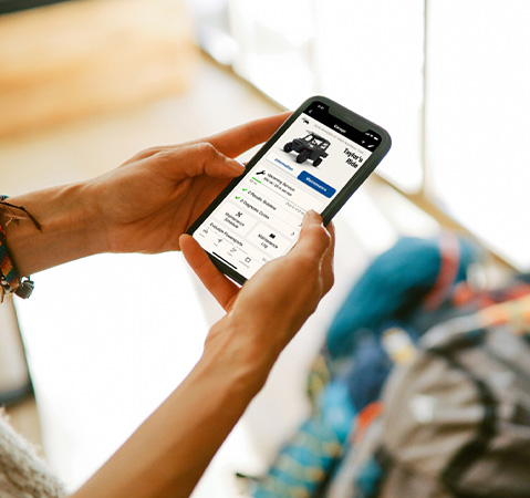 A person using their smartphone to view their Polaris account.