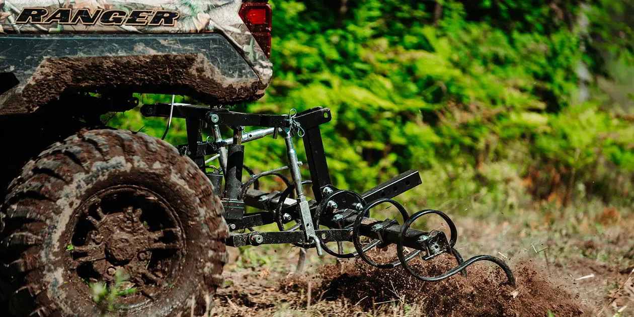 Closeup view of the Soil S-Tine Cultivator Kit attached to a Ranger XP 1000 NorthStar Edition