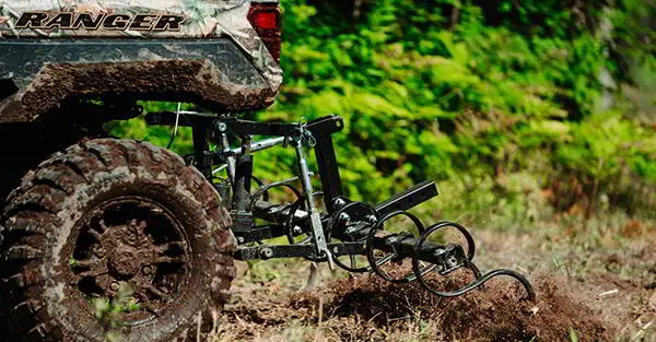 Closeup view of the Soil S-Tine Cultivator Kit attached to a Ranger XP 1000 NorthStar Edition