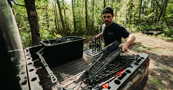 Man loading equipment in a Ranger cargo box