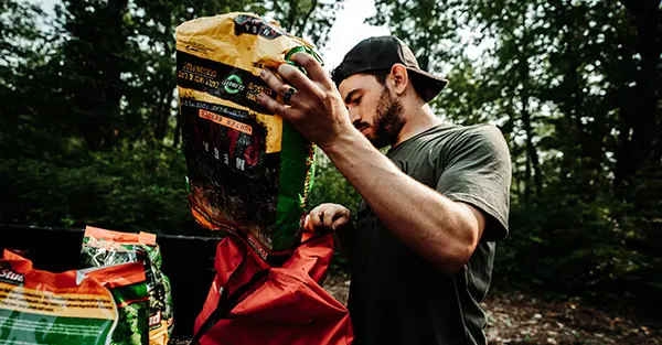 A man prepping up some seeds to plant in the ground