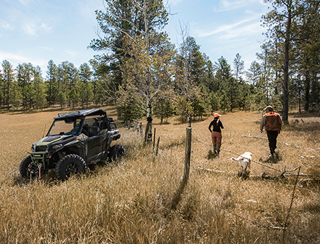 Hunters getting their Polaris General vehicles ready to leave their cabin