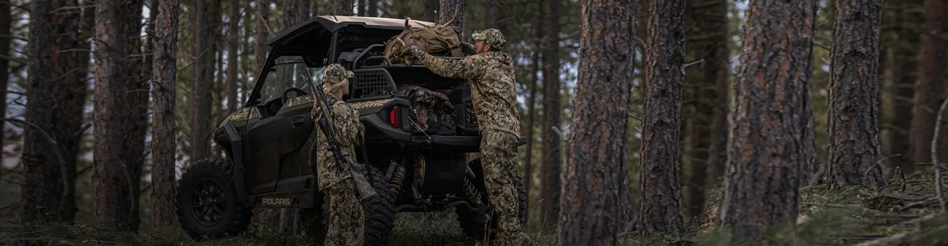 Two hunters with their Polaris General in the woods