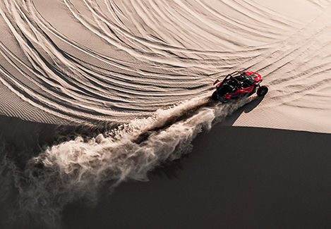 Polaris RZR seen from the top as it creates a sand trail across the dunes
