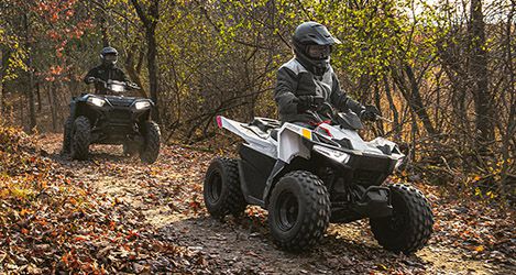 A young kid riding his Outlaw 70 EFI on the road