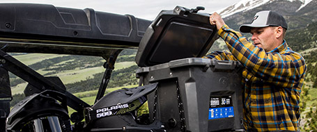 A man opening the lid of a Northstar Cooler