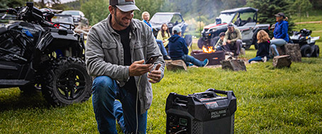 A man using a Polaris Power Generator to charge up his phone