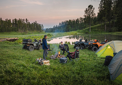 A group of Polaris Off-Road riders camping outside next to their vehicles