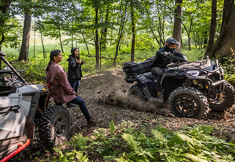 Three friends having some fun time with their Polaris Off-Road vehicles