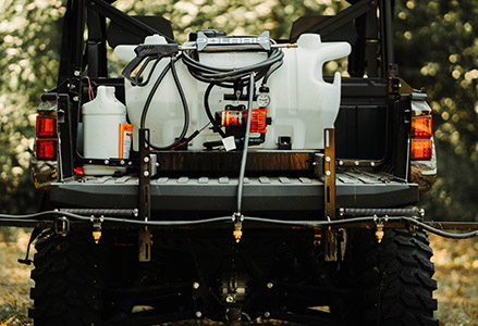 Back view of a Polaris Ranger carrying water sprayers