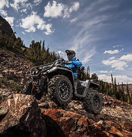 Sportsman trailing up a rocky mountain