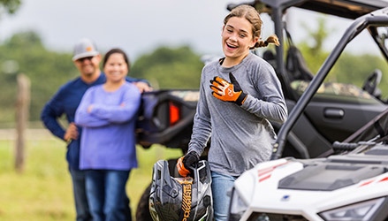 A girl walking towards her RZR EFI 200