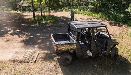 A Ranger vehicle with a rake cleaning a yard