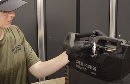 a man viewing a p2000i generator on a desk