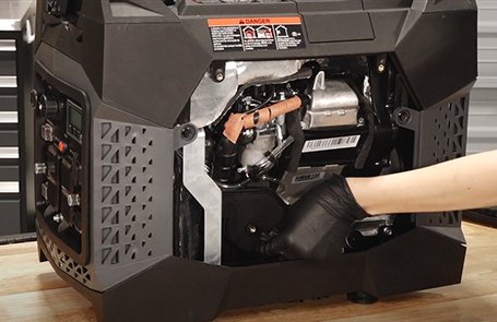 a man viewing a p2000i generator on a desk