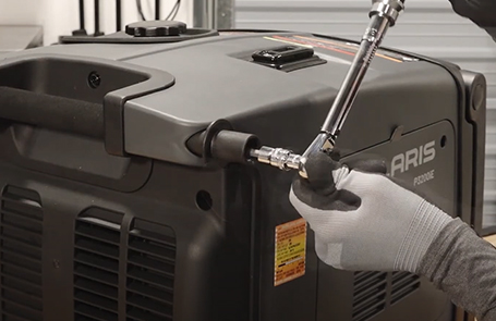 closeup of a man working on a p3200ie generator on top of a working table