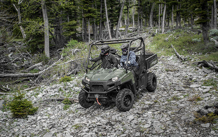 ranger 570 full size going through a trail