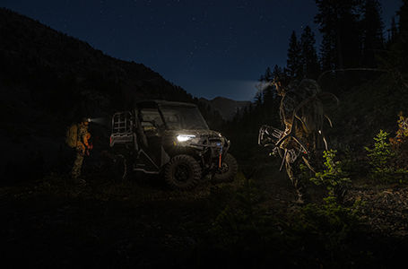 A group of hunters with their Ranger vehicle in the dark