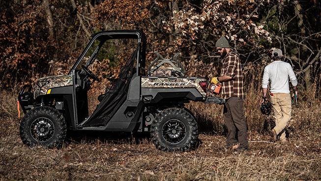 Side view of a Ranger XP 1000 Big Game Edition in the woods