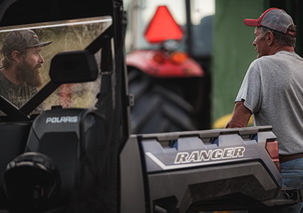 Two Ranger XP 1000 owners hanging out with their vehicle