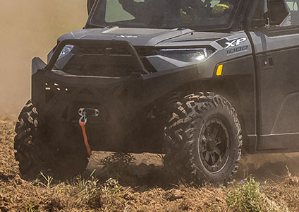 Ranger 1000 racing on a trail featuring pro armor wheel & tire sets