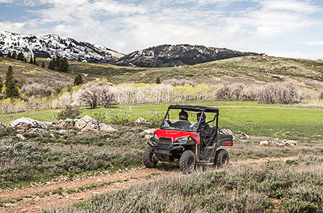 2 riders in a ranger 500 driving on an open trail
